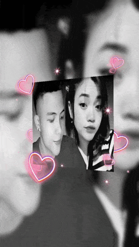 a black and white photo of a man and a woman with pink hearts surrounding them