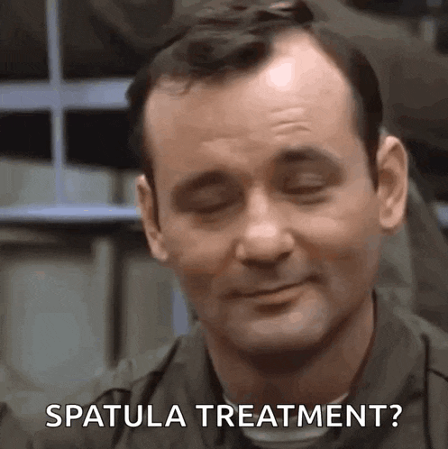 a close up of a man 's face with the words `` spatula treatment '' written on it .