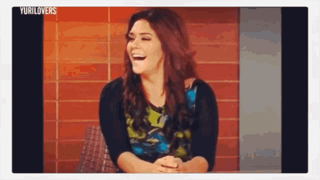 a video of a woman laughing with the words yurilovers on the bottom right