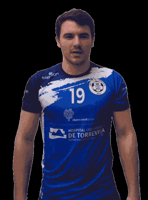 a man wearing a blue and white jersey with the number 19 on it