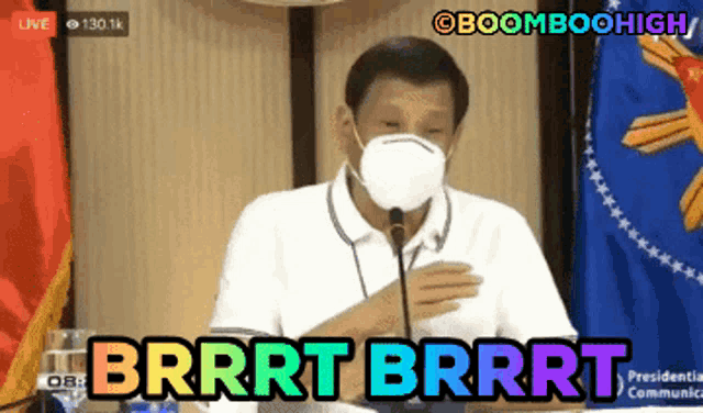 a man wearing a mask is speaking into a microphone and the words brrrt brrrt are above him