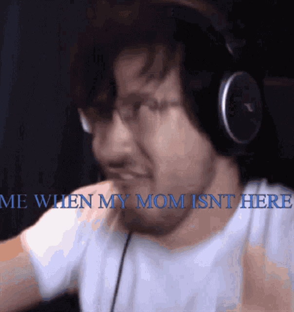 a man wearing headphones with the words me when my mom is n't here
