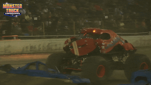 a monster truck is driving down a track with the words monster truck throwdown written on the bottom