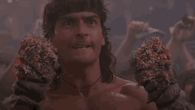 a shirtless man is holding two ice cream cones covered in candy
