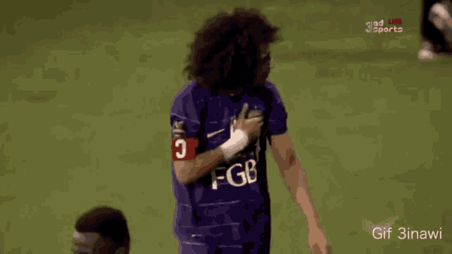a soccer player with curly hair wearing a purple jersey with the number 10 on it