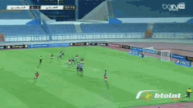 a soccer game is being played in a stadium sponsored by pepsi and orange
