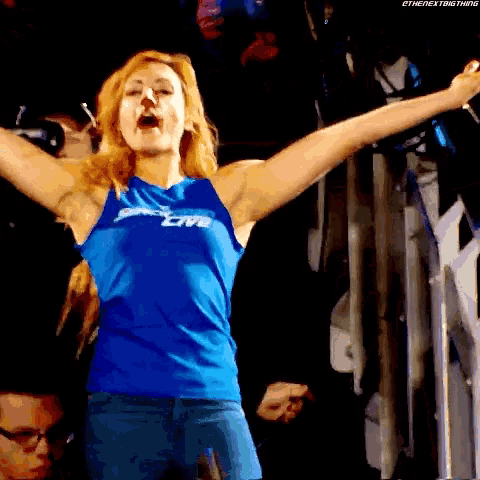 a woman wearing a blue shirt that says smackdown live