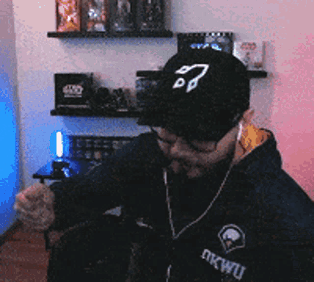 a man wearing a hat that says star wars