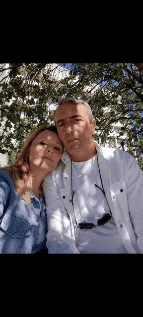 a man and a woman are posing for a picture