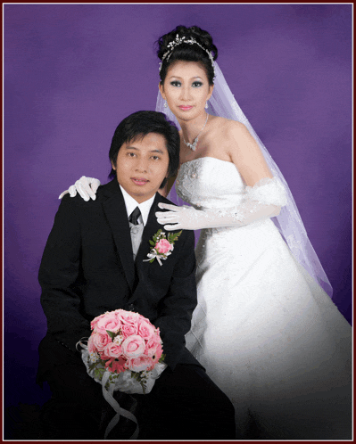 a bride and groom pose for a picture with a purple backdrop