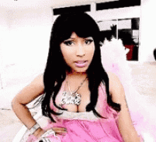 a woman is wearing a pink dress and a necklace that says barbie