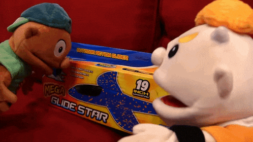 two stuffed animals are looking at a mega glide star toy