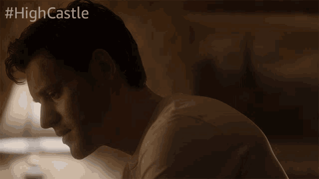 a close up of a man 's face with #highcastle written on the bottom