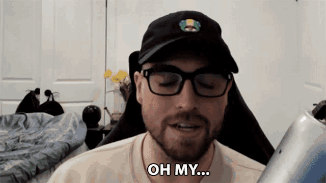 a man wearing a hat and glasses says oh my