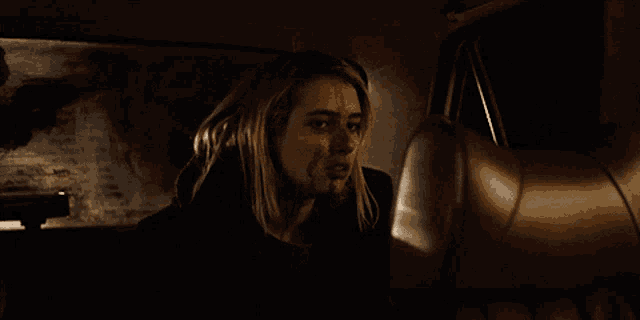 a woman with blood on her face is in a car