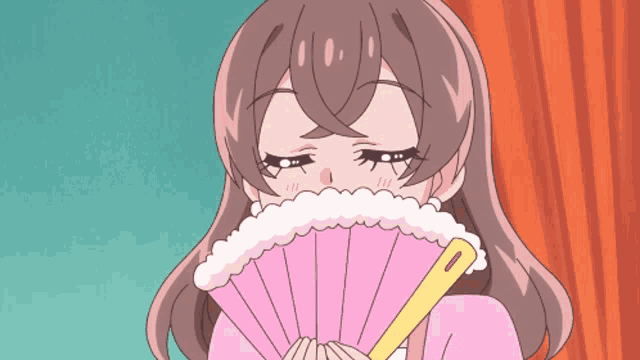 a girl in a pink dress is holding a pink fan in front of her face