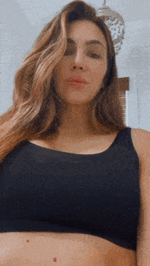 a woman in a black bra is looking down
