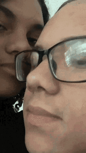 a close up of a woman wearing glasses and a man wearing glasses
