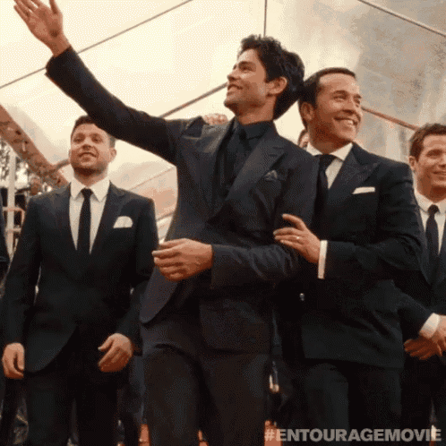 a group of men in suits and ties are standing in front of a tent with the entourage movie written on the bottom