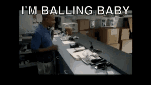 a man standing at a counter with the words " i 'm balling baby " on the bottom