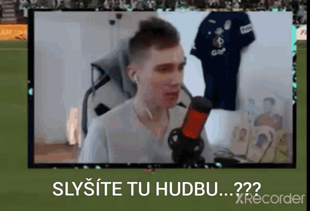 a video of a man talking into a microphone with the words slysite tu hudbu