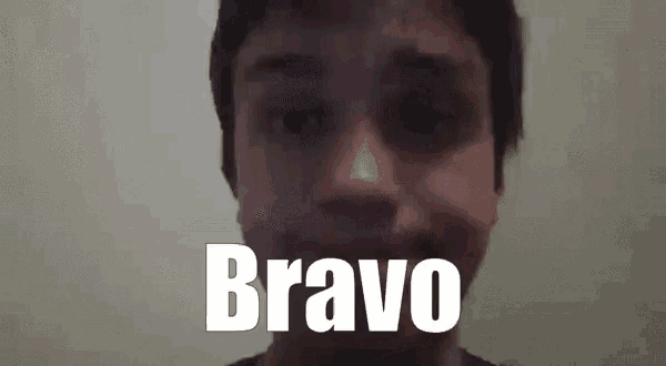 a close up of a man 's face with the word bravo written in white letters .