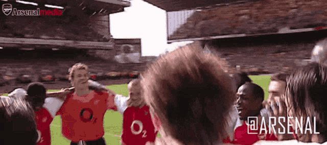 a group of soccer players wearing jerseys with the letters o2 on them are huddled together