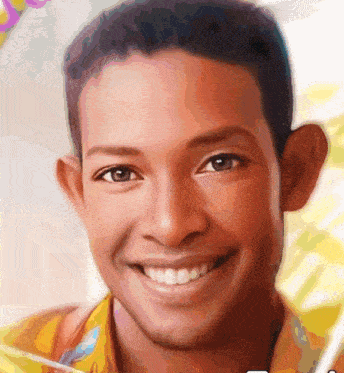 a close up of a young man 's face with a smile