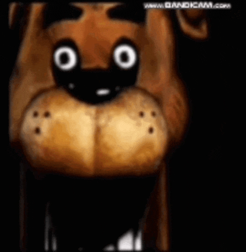 a close up of a cartoon character 's face with big eyes in a dark room .
