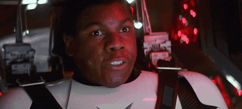 a man in a storm trooper uniform is sitting in a car with a red light behind him