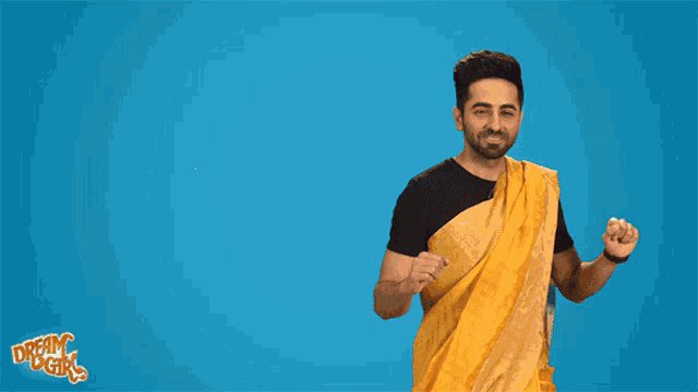 a man in a yellow saree is standing in front of a blue background that says woohoo
