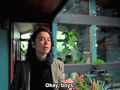 a woman says okay boys while holding a flower