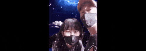 a man and a woman are standing next to each other in the snow .