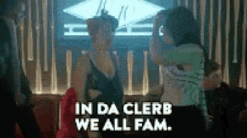 a group of people are dancing in a club and one of them is saying `` in da cleb we all fam '' .