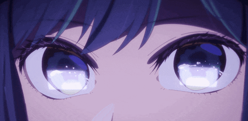 a close up of a person 's eyes with a blue background