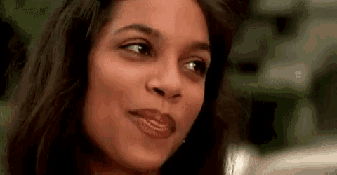 a close up of a woman 's face with her eyes closed and her mouth open .