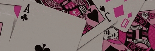 a pile of pink and black playing cards with the ace of spades in the center