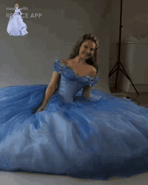 a woman in a blue ball gown with the words made with reface app below her
