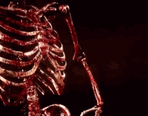 a bloody skeleton is holding a microphone in front of a sign that says " the terminator wins "