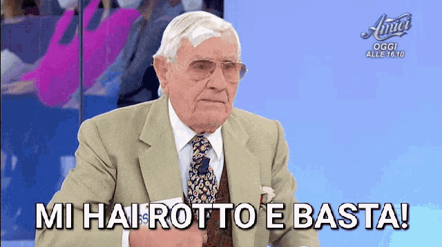 an older man in a suit and tie says mi hai rotto e basta