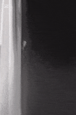 a close up of a black and white surface with the letter m in the corner