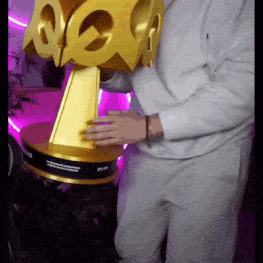 a person is holding a trophy that has the word aoc on it
