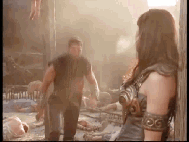 a man and a woman are standing next to each other in a room with a lot of dead people .