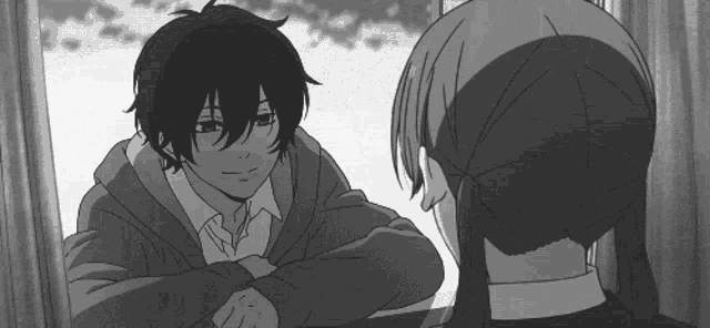 a black and white photo of a boy and a girl looking at each other