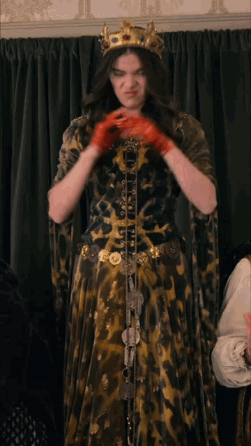 a woman in a leopard print dress and a crown