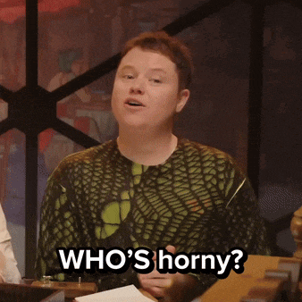 a man in a green shirt says who 's horny while smiling