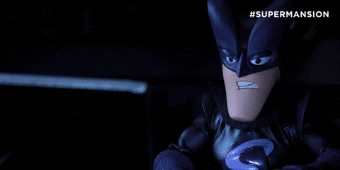 a poster for supermansion shows a batman standing in a dark room