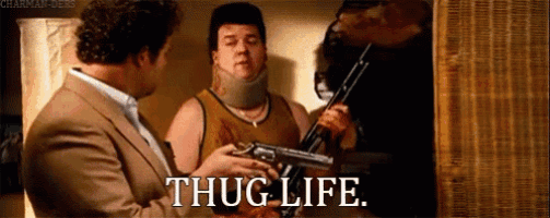 a man with a neck brace is holding a gun while another man says thug life .
