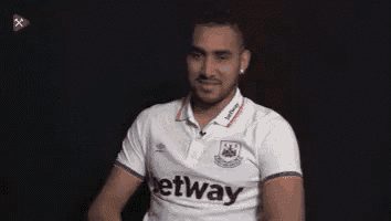a man wearing a white betway shirt is smiling