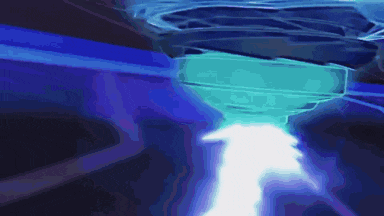 a blue light is coming out of a blue object in the dark